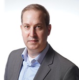 Picture of man with suit looking into the camera